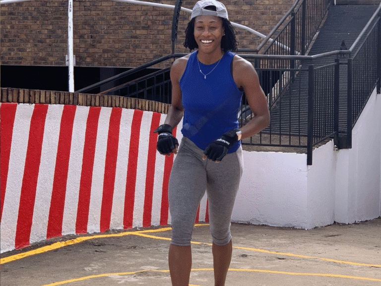 A smiling woman with a baseball cap and workout gear is shown outdoors, representing the joyful and diverse training environments that can be part of a fitness program like FitRanX.